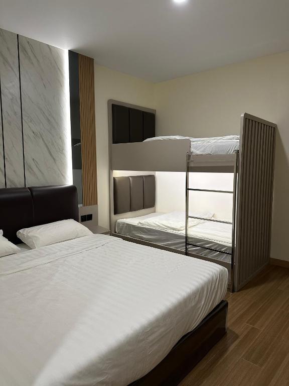 a bedroom with two bunk beds and a window at Serenity Homestay Penuin Batam in Batam Center