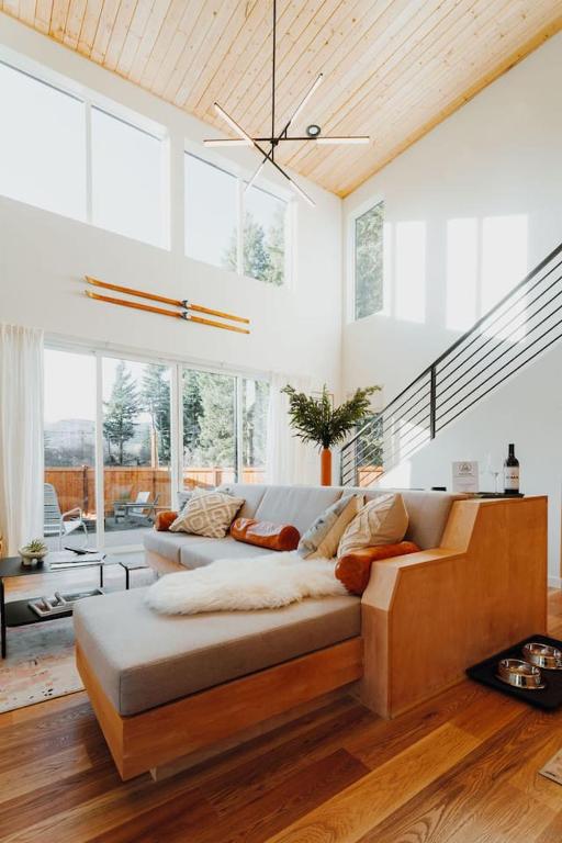 a living room with a couch and some windows at Camp Alpine in Packwood