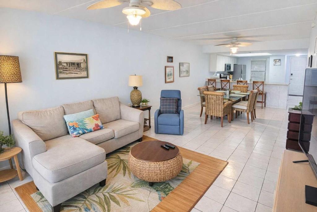 a living room with a couch and a table at Resort like super heated pool & direct beach front in South Padre Island