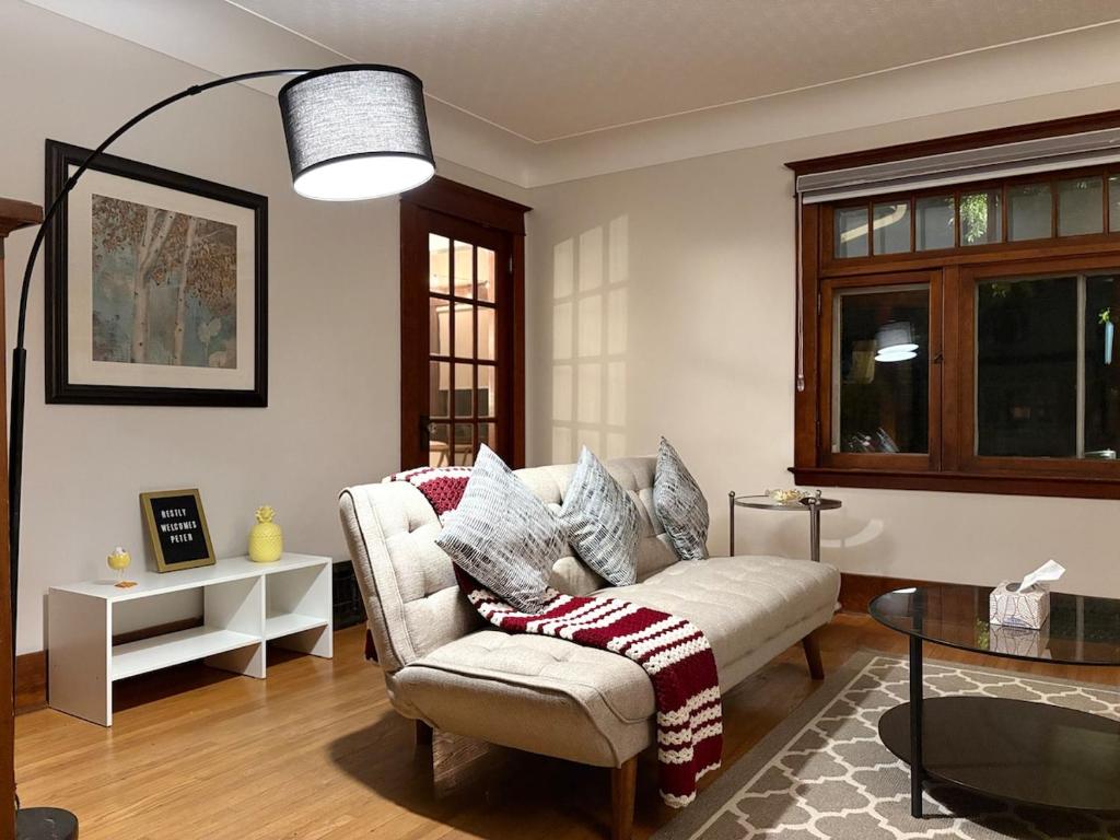 a living room with a couch and a table at Restly an Elegant Home by Whyte Ave in Edmonton
