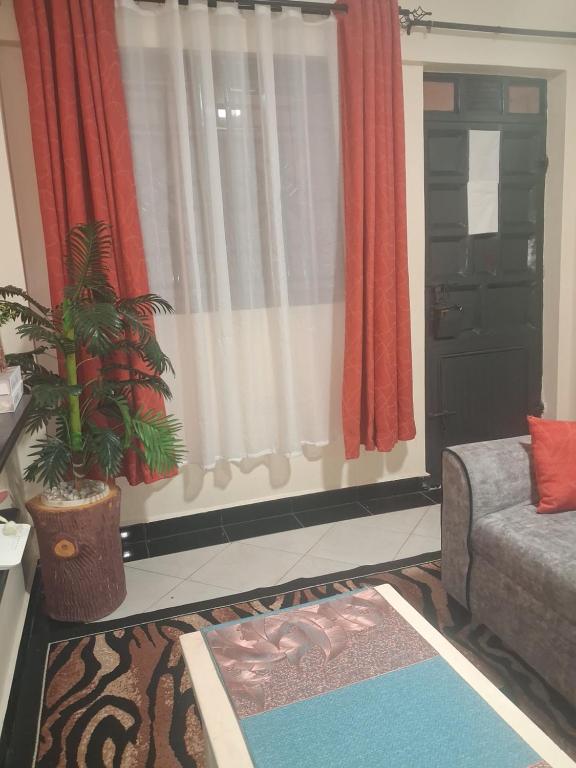 a living room with a couch and a window at PAZURI - Homes in Voi
