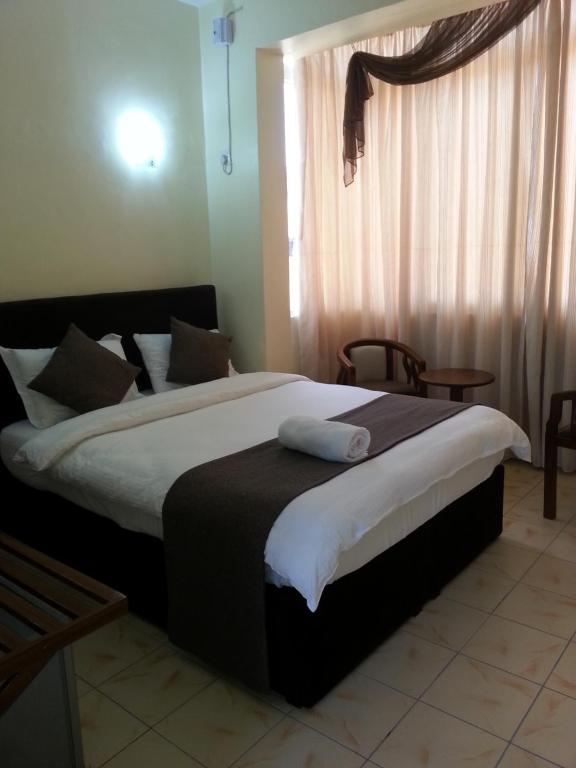 Postel nebo postele na pokoji v ubytování Regency Inn Tudor
