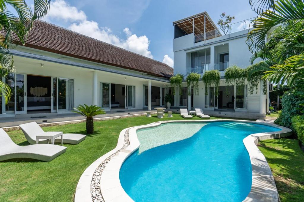 a swimming pool in the backyard of a house at Luxury 5BR Villa with Rooftop BBQ Pool 500M to Beach in Canggu