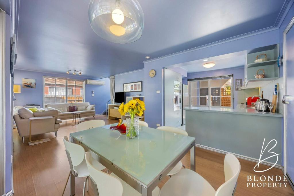 a blue living room with a table and chairs at La Maison Bleue in Ballarat