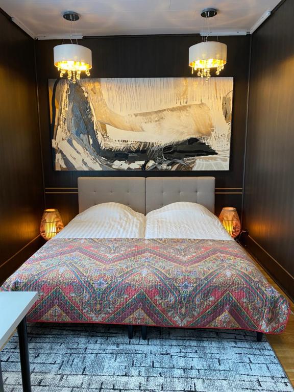 a bedroom with a bed with a painting on the wall at Karula Stay - 2 Bedroom City Centre Apartment in Antsla