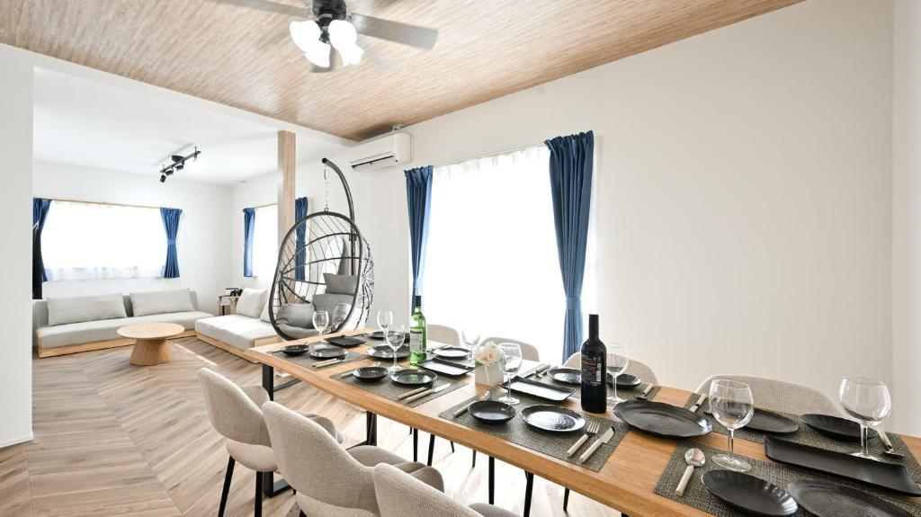 a dining room with a table and some chairs at LAZULI Fukutsu in Fukuoka