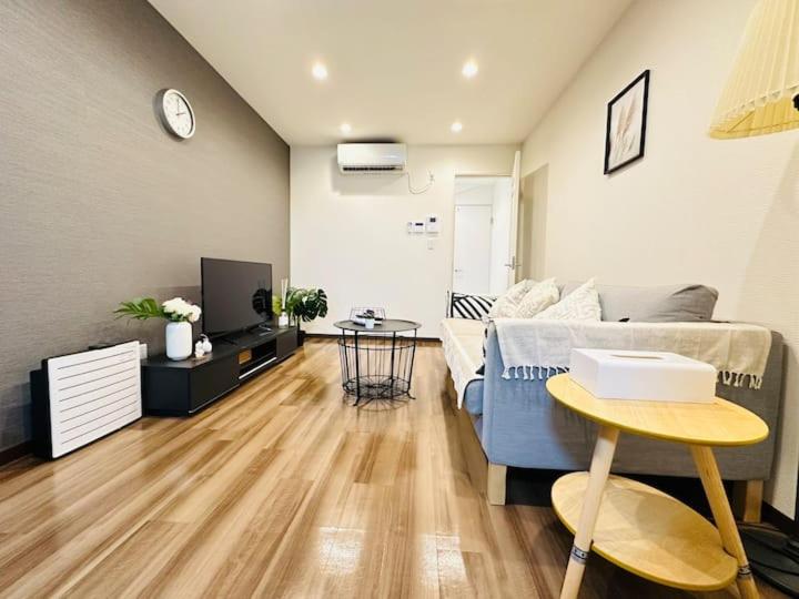 a living room with a couch and a table at 楽途居 in Osaka