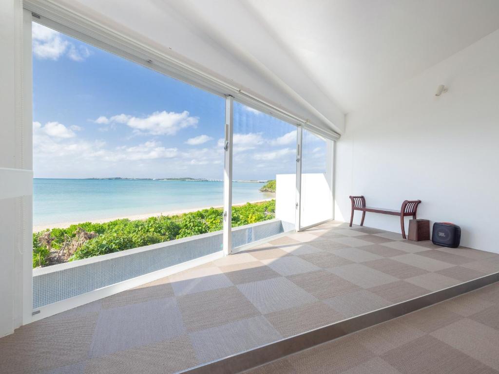 a room with a view of the ocean at VOYAN Resort MiyakojimaーAZOMARE アゾマーレ in Miyako-jima