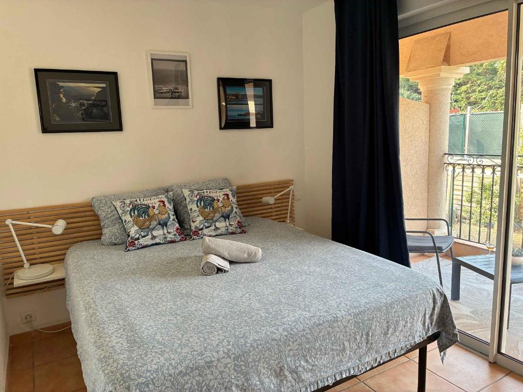 a bedroom with a bed with a blue comforter at Orangeraie du Cap d'Antibes in Antibes