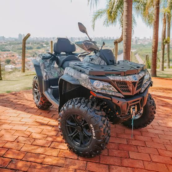 a quad bike parked on top of a brick ground at Passeio de quadriciclo com hospedagem in Guapimirim