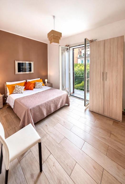 a bedroom with a large bed and a sliding glass door at Opera Prima 28 in Palermo