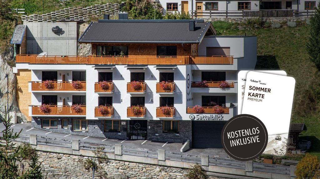 a building with a sign in front of it at Haus Sattelblick in Sankt Anton am Arlberg