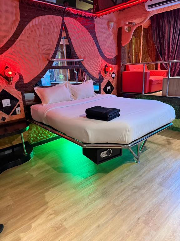 a bedroom with a bed in a red tent at PENTHOUSE PATTAYA in Pattaya
