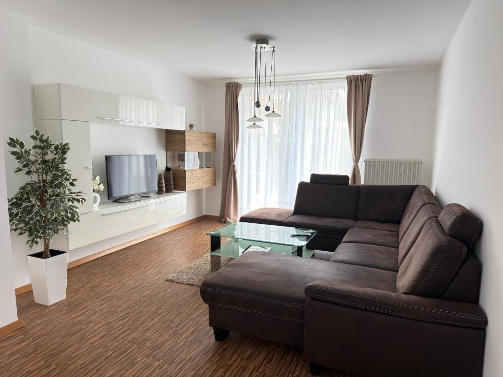 a living room with a couch and a table at Bogi's Ferienhaus - Pension in Laakirchen