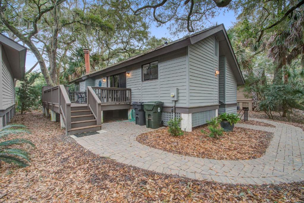 a tiny house with a porch and a patio at West Beach Oceanwoods Cottage 442 in Kiawah Island