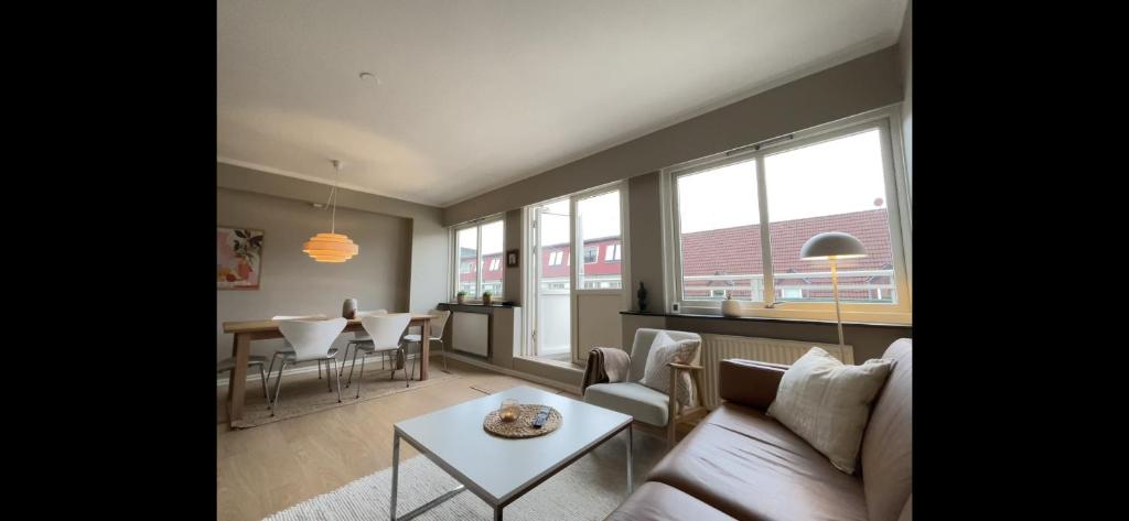 a living room with a couch and a table at Apartment Bergen Central - private balcony in Bergen