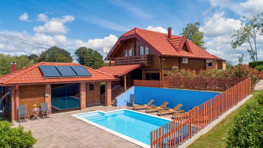 a house with a swimming pool and a house with a red roof at Villa Nina by Villas Guide in Ludbreg