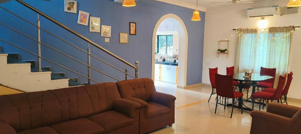 a living room with a couch and a table at Rooms in the 4 Bedroom House, Morjim Beach 500 meters away in Morjim