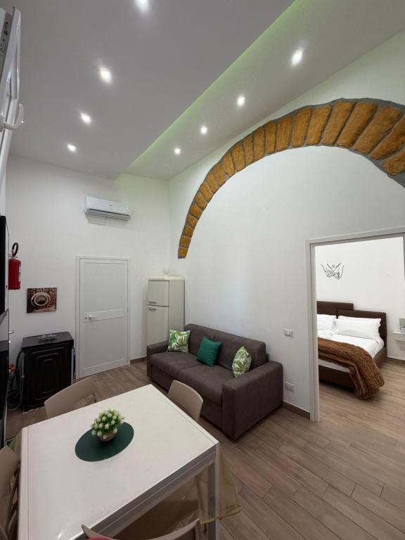 a living room with a couch and a bed at Luxury Royal House 3 in Palermo