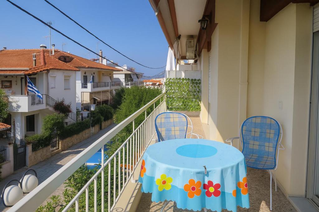 a table and chairs on the balcony of a building at Balcony Sea Hanioti Stay in Hanioti