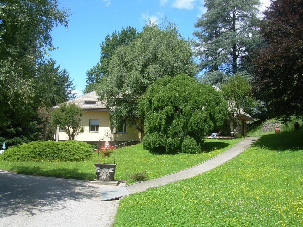 a house with a road in front of a yard at Il Colombé B&B in Barzanò