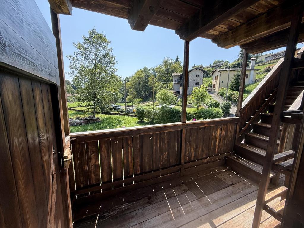 a view from the porch of a wooden house at Albergo Diffuso Balcone sul Friuli in Clauzetto