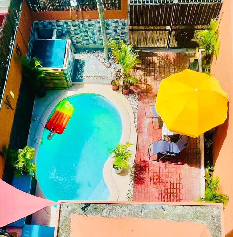an overhead view of a swimming pool with a yellow umbrella at Modern House with Pool in Grand-Baie