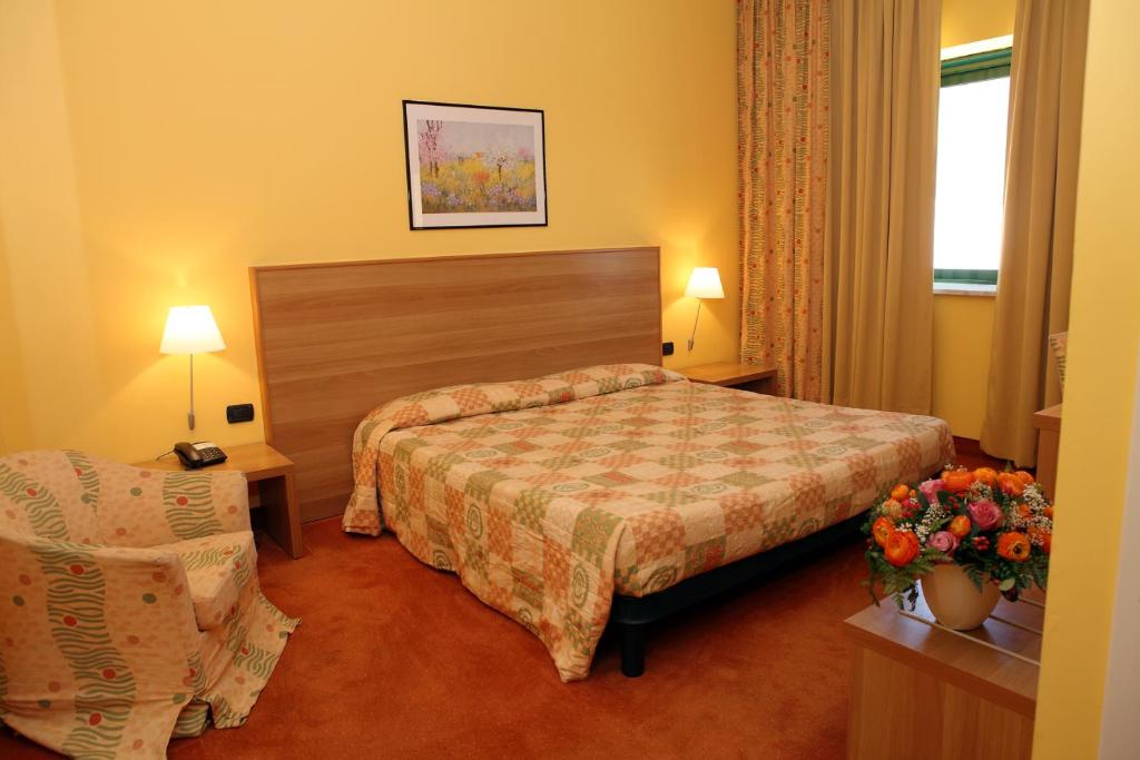 Postel nebo postele na pokoji v ubytování Hotel Romanisio