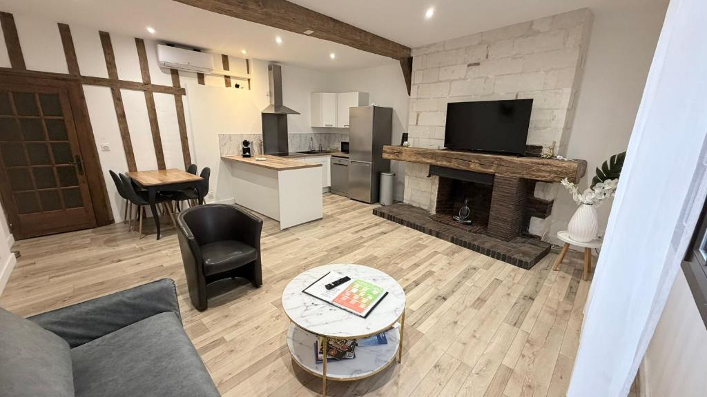 a living room with a couch and a fireplace at La Champenoise in Troyes