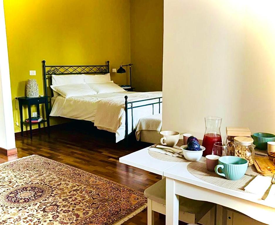a room with a bed and a table with food on it at AGAVE Suite in Lecce