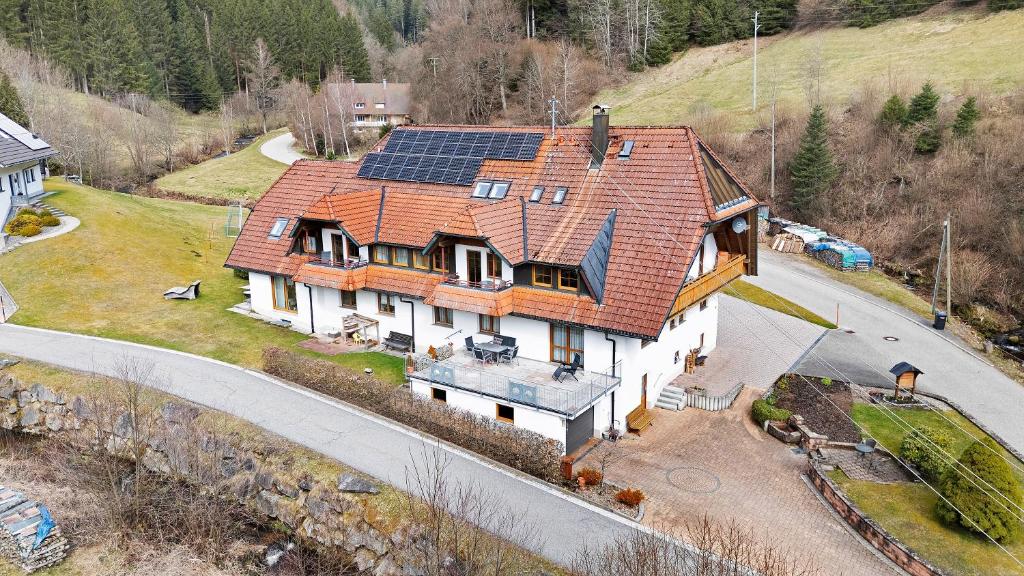 an aerial view of a house with solar panels on it at Gästehaus Herrmann in Bad Rippoldsau-Schapbach