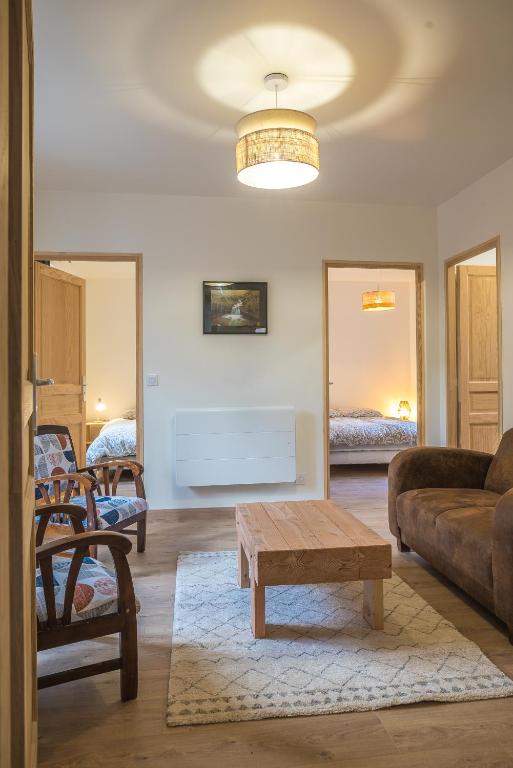a living room with a couch and a coffee table at le clos de la monne in Saint-Amant-Tallende