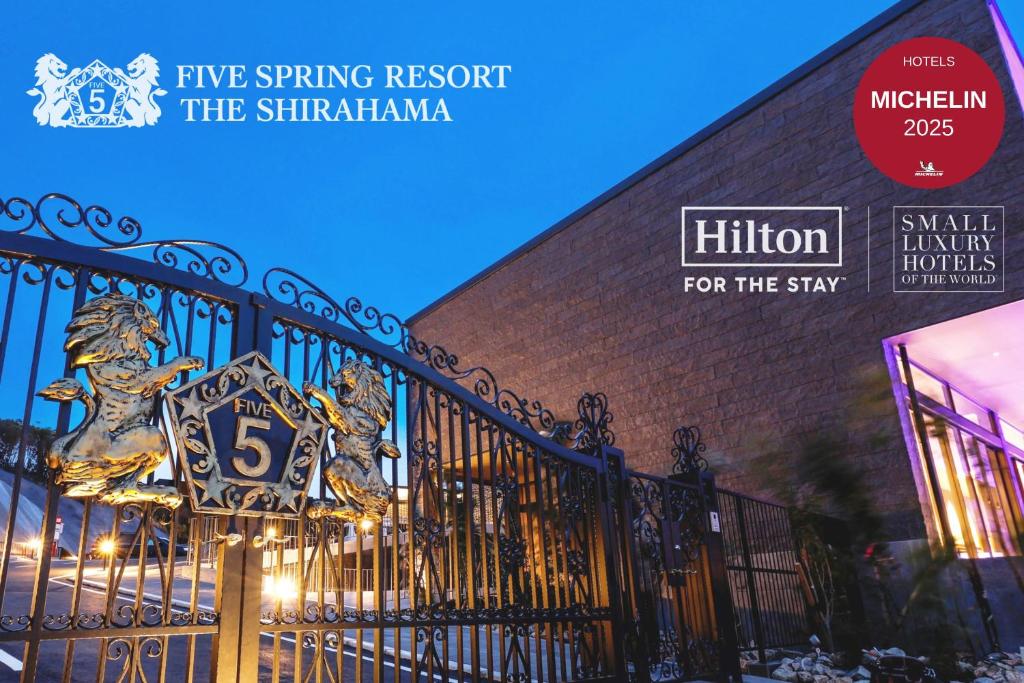 a gate with a sign on it in front of a building at FIVE SPRING RESORT THE SHIRAHAMA in Shirahama