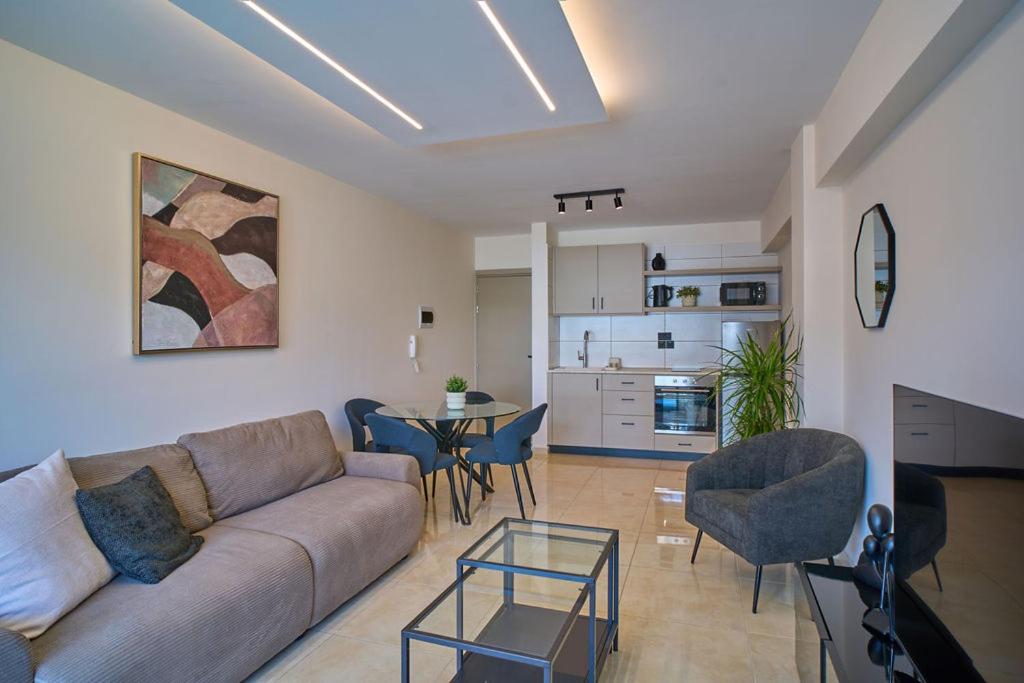 a living room with a couch and a table at Marianna Hotel Apartments in Limassol