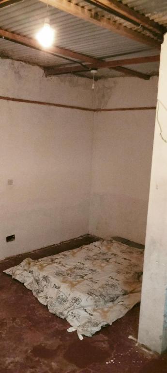 an empty room with a mattress on the floor at Yua Residence in Machakos