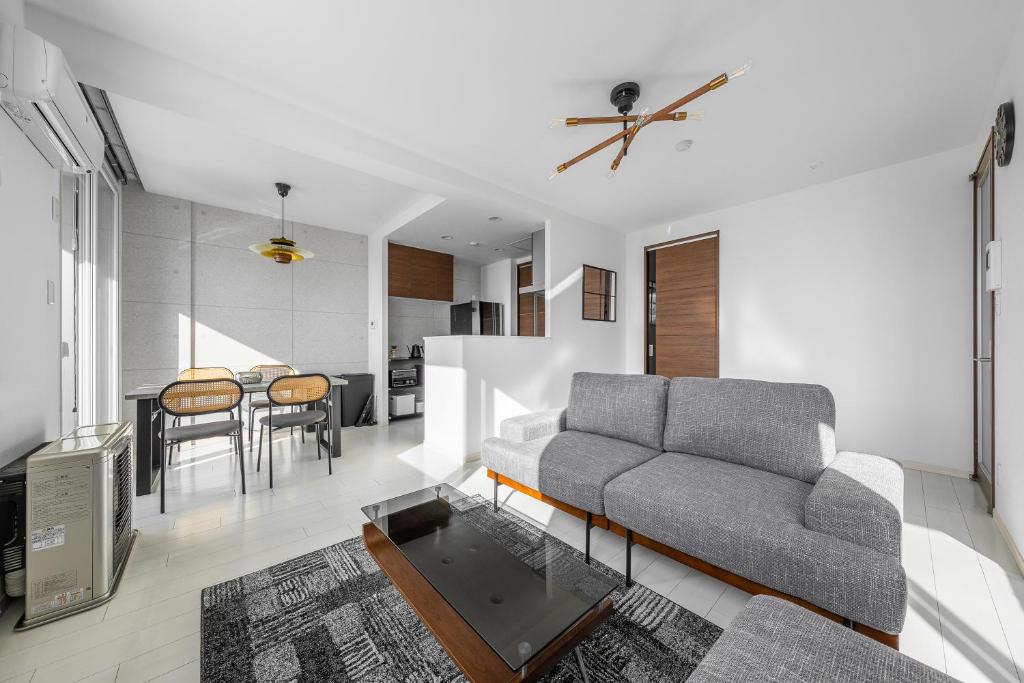 a living room with a couch and a table at Grandia 302 in Sapporo