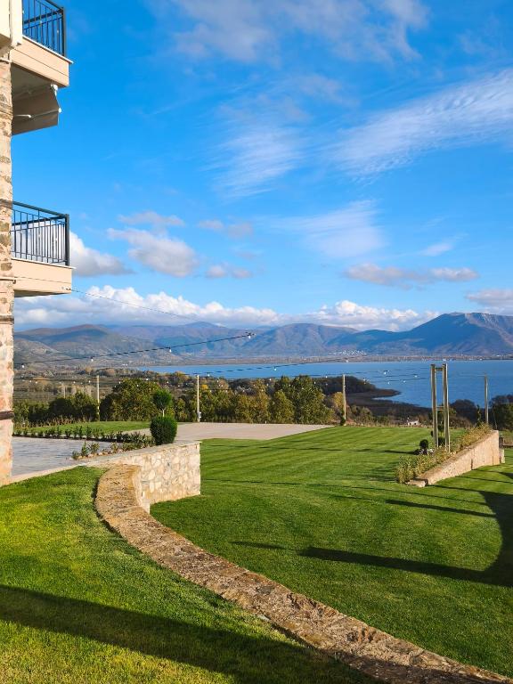 a golf course with a view of the water and mountains at Hotel Agnanti Unique Hospitality in Kastoria