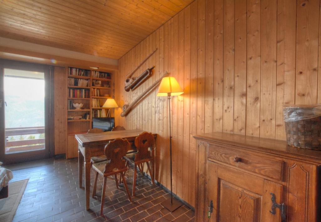 a dining room with a table and two chairs at Antares 403 au centre a Anzere in Anzère