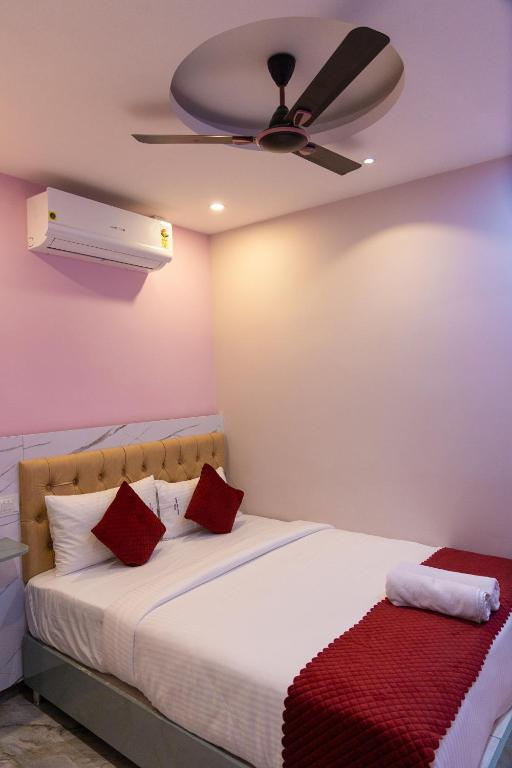 a bedroom with a bed with a ceiling fan at P V Grand in Dindigul