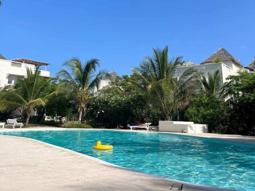 a swimming pool with a yellow toy in the water at Villa Gladys in Watamu