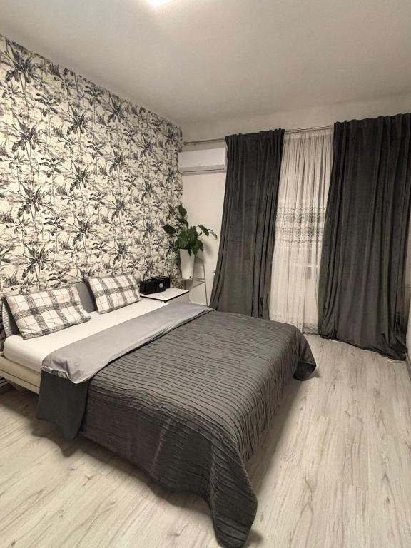 a bedroom with a large bed and a wall mural at Studio in the center in Craiova
