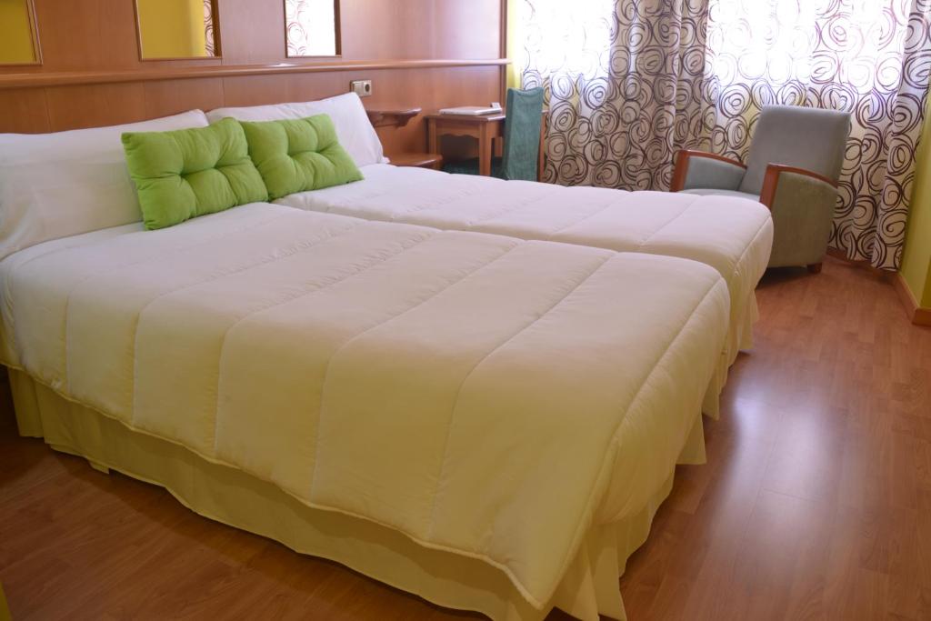 a large white bed in a hotel room at Hotel Aro'S in Casas Ibáñez