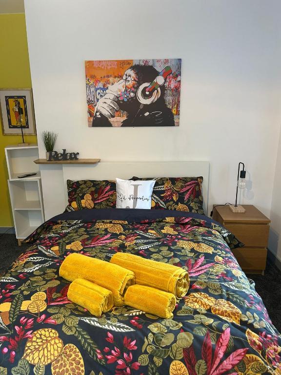 a bed with two yellow pillows on top of it at 2 Newcastle Street in Crewe