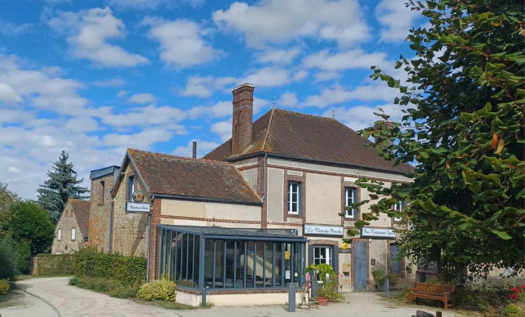 an old brick building with a chimney on top at Le Clos du Perche in Boissy-lès-Perche