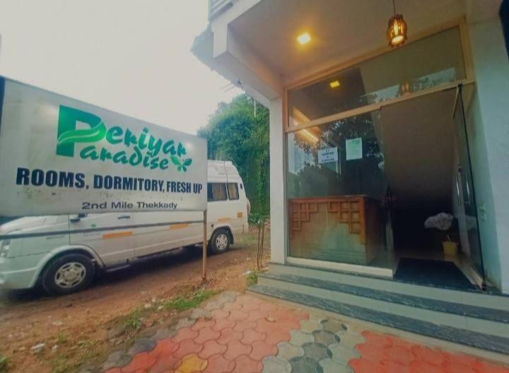 a white van parked in front of a building at PERIYAR Paradize Inn,Kumily in Thekkady