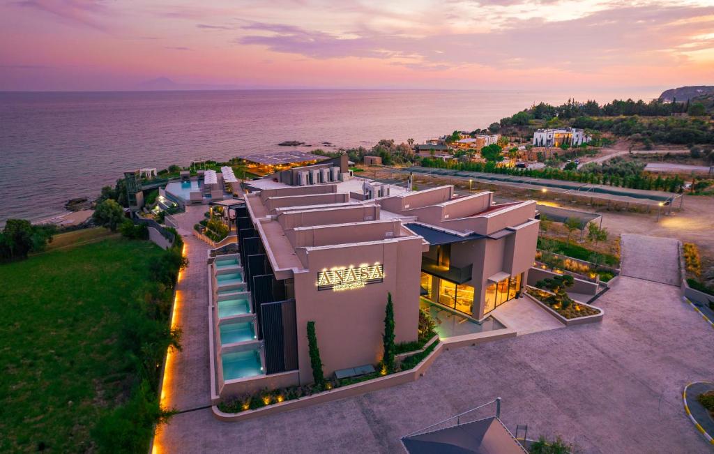 an aerial view of a building next to the water at Anasa Luxury Resort in Elaiokhórion