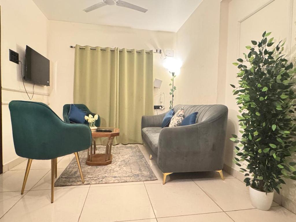 a living room with two chairs and a couch at Premium 2BHK Apartment by Key Stays - Hyd in Hyderabad