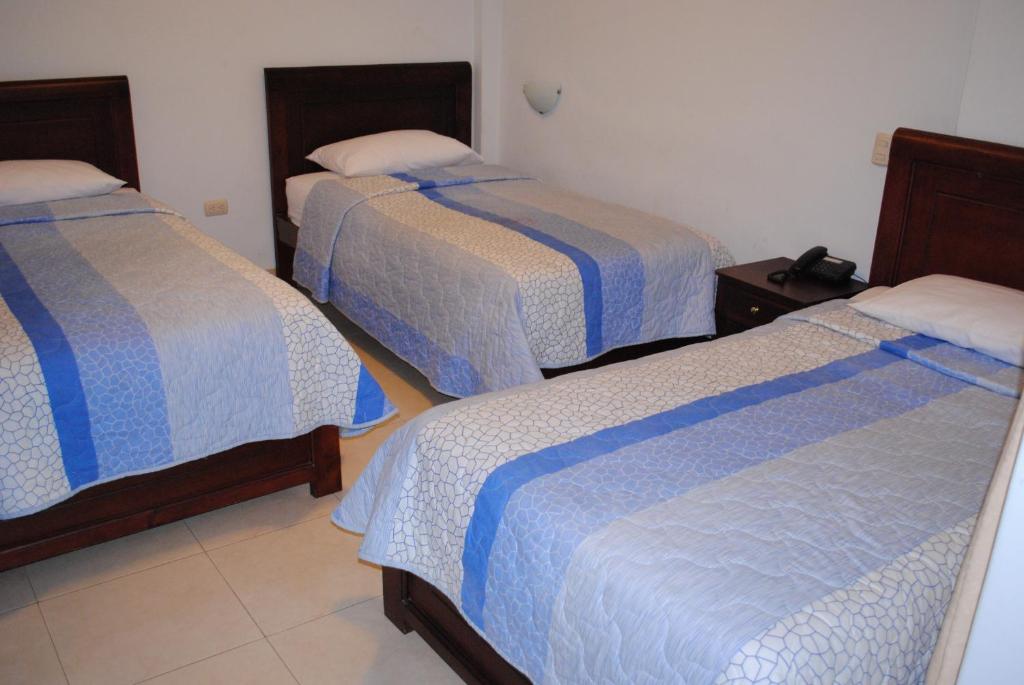 Postel nebo postele na pokoji v ubytování Hotel Caluva