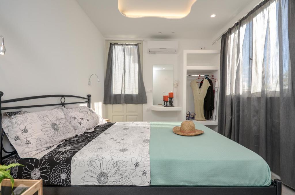 a bedroom with a bed with a hat on it at Depis suites naxos in Naxos Chora