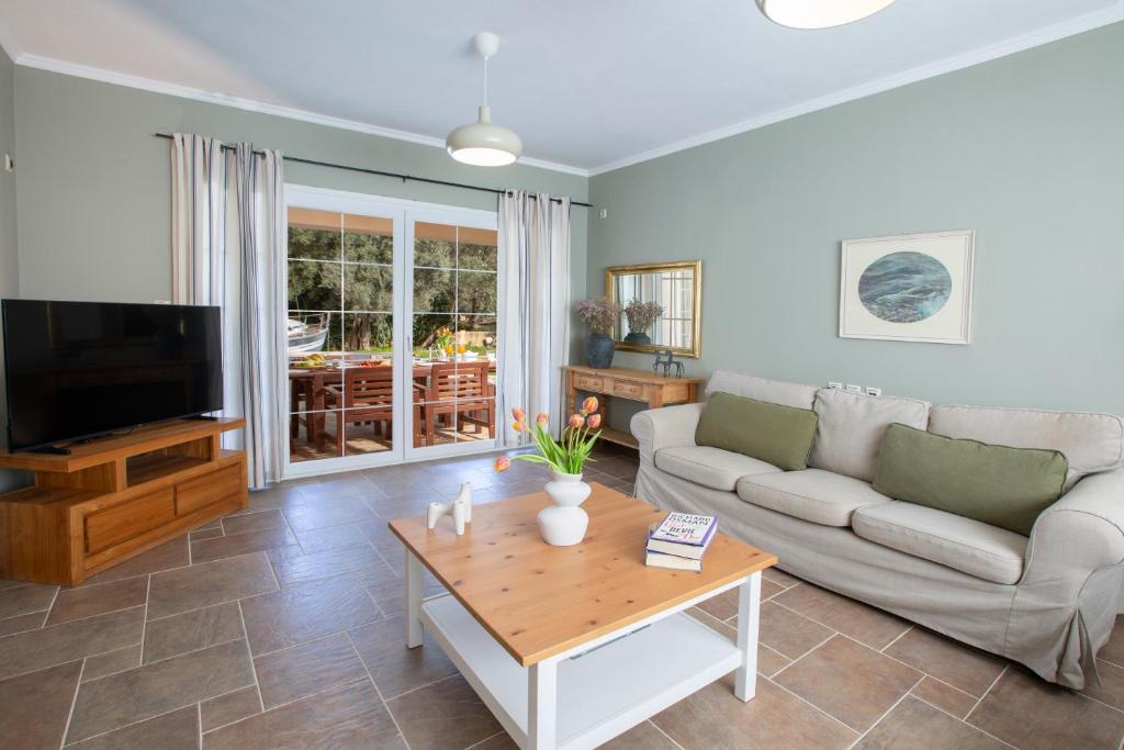 a living room with a couch and a coffee table at Villa Morris in Nydri